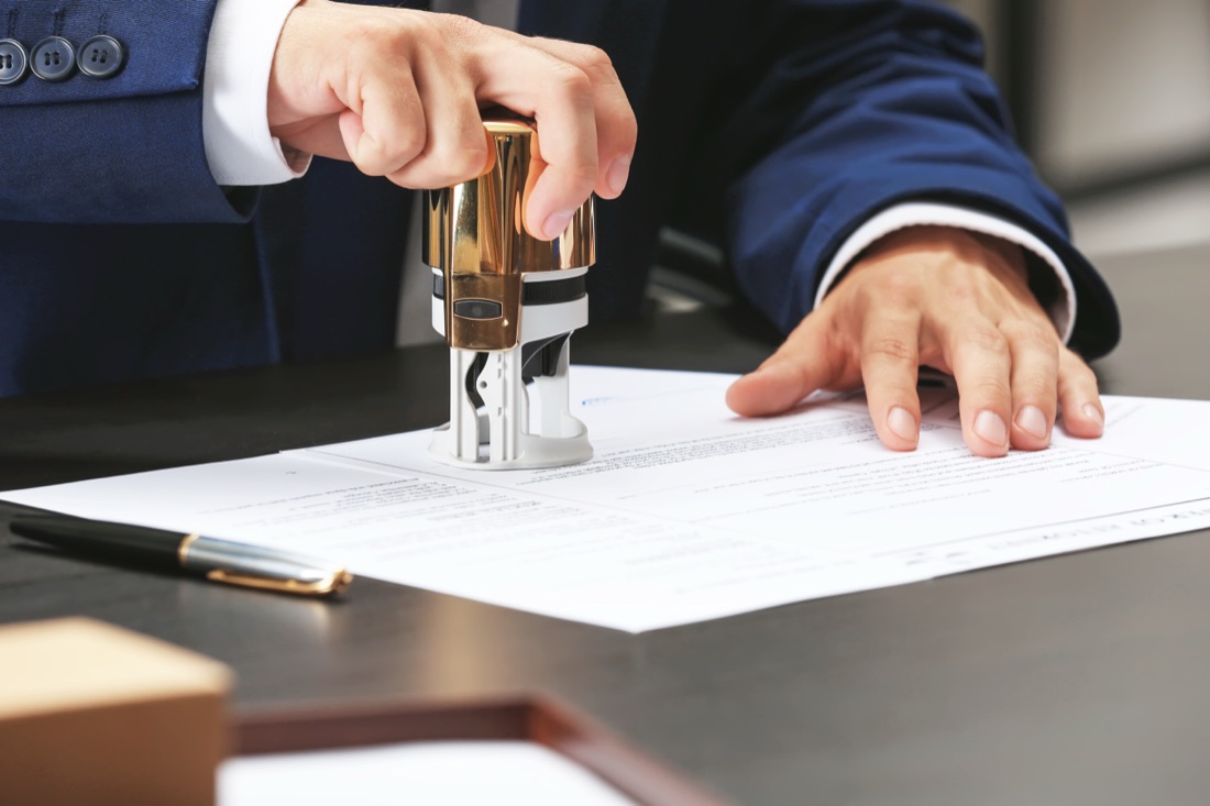 Hand stamping document suit sleeve papers pen
